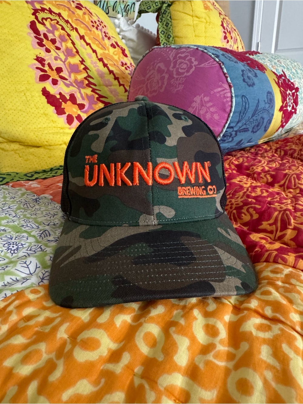 The Unknown Brewing Co. Camo Hat with Orange Logo